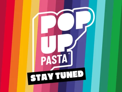 "POP UP PASTA Stay tuned" auf bunt-gestreiften Hintergrund.